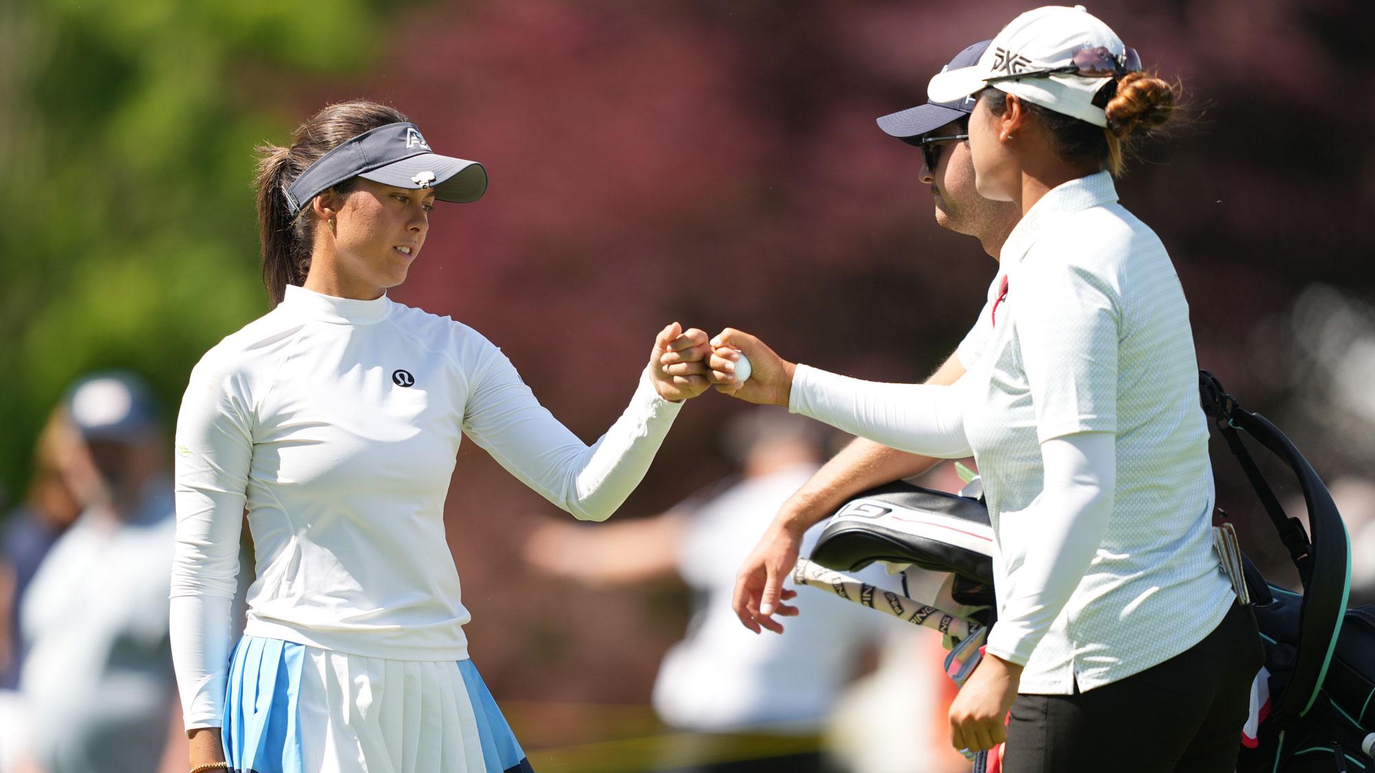 (L-R) Yana Wilson of the United States fist bumps Gina Kim of the United States on the 16th green during the third round of the Dow Championship 2026 at Midland Country Club on June 13, 2026 in Midland, Michigan